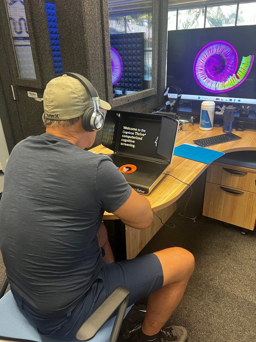 A guest at Serenity Hearing Aid Centers completing a Cognivue Thrive computerized cognitive screening in-office